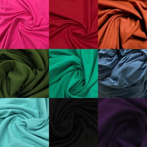 May include: A collection of nine fabric swatches in various colors, including pink, red, orange, green, blue, turquoise, black, and purple. The fabric is smooth and has a slight sheen.