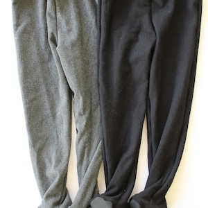 May include: Two pairs of fleece-lined leggings, one gray and one black. The leggings have a fold-over cuff at the ankle.