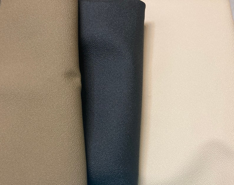 May include: Three fabric swatches, one beige, one black, and one off-white. The fabric has a textured surface.