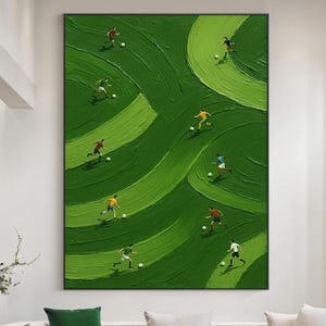 May include: A large rectangular wall art piece featuring an abstract green field with thick, textured brushstrokes. Several small figures in various colored jerseys are depicted playing soccer across the field, each accompanied by a small white ball.
