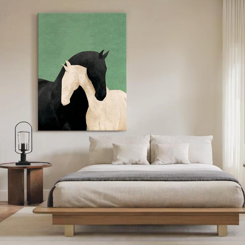 May include: A canvas print featuring two horses. One horse is black, and the other is white. The horses are positioned close together, with the black horse's head above the white horse. The background is a solid green color.