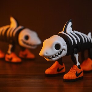 May include: Two toy shark figures with skeleton detailing and orange sneakers. The sharks have white skulls, black bodies, and white rib cages. The sneakers have black swoosh logos. The background is a blurred, dark brown.