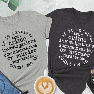a couple of shirts that are next to a cup of coffee