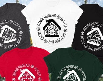May include: Five different colored t-shirts with a white gingerbread house design and the text "Gingerbread House Decorating Crew" in a circle around the house.