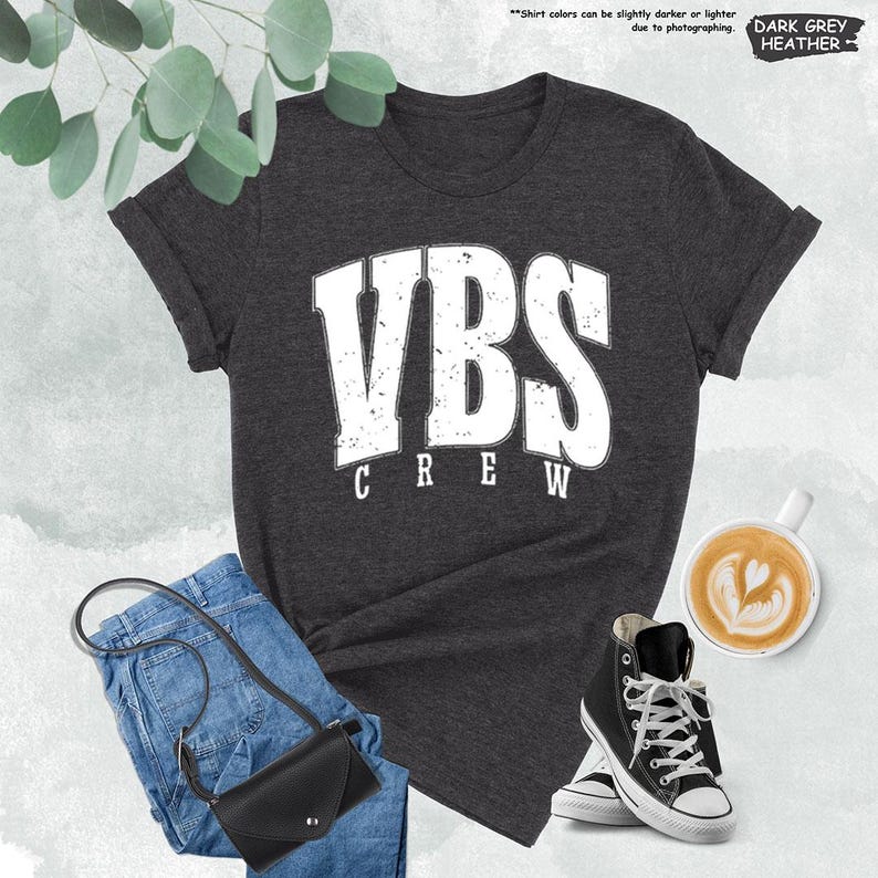 a t - shirt that says vbs crew next to a pair of jeans and