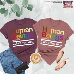 two t - shirts that say human beings and colors may vary