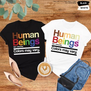 two t - shirts that say human beings and colors may vary