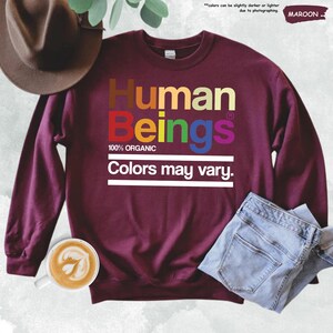 a maroon sweatshirt with the words human beings on it