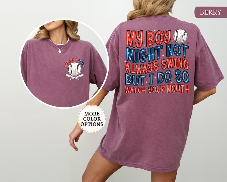 May include: Berry-colored t-shirt with baseball-themed graphics. The front features a baseball and crossed bats with "Baseball Mama" text. The back displays text that reads "My boy might not always swing but I do so watch your mouth" with baseball graphics.