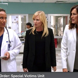 May include: Three women in a hospital setting. The woman on the left is wearing a white lab coat over a blue shirt and a stethoscope around her neck. The woman in the middle is wearing a black blazer over a black shirt. The woman on the right is wearing a white blazer over a gray shirt. The text "Law & Order: Special Victims Unit" is at the bottom of the image.