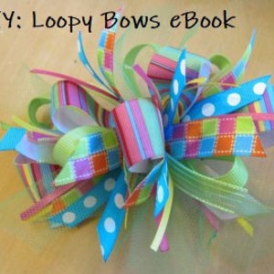 May include: A colorful loopy bow made with multiple ribbons in various patterns, including stripes, polka dots, and plaid. The bow is tied with a knot in the center and has a fluffy texture.