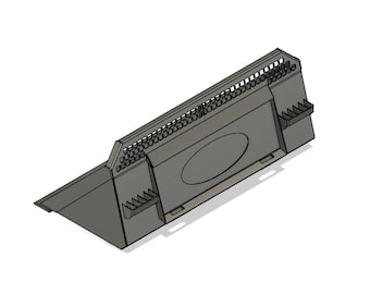 May include: A gray metal construction barrier with a grid pattern and a circular opening. The barrier is angled and has a flat base.