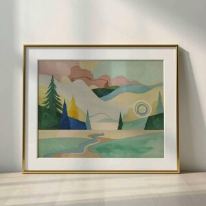 May include: A framed watercolor landscape painting with a gold frame. The artwork depicts a stylized mountain scene with trees, a river, and a sun. The color palette includes greens, blues, yellows, and pinks.