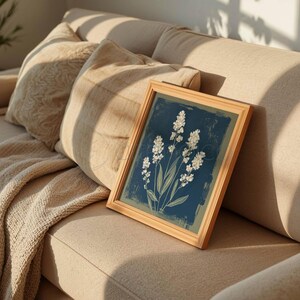 Stylized botanical painting featuring slender olive-green leaves and textured white flowers on a dark moody background. Square format digital art with a vintage aesthetic, perfect for modern farmhouse or cottagecore wall decor.