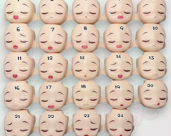 May include: Twenty-four different doll face plates with various expressions, numbered 1 through 24.