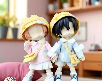 May include: Two small, stylized figures of children, one in pink and the other in blue, each wearing a yellow hat and carrying a yellow satchel. The figures are holding hands and wearing white sneakers. The background is blurred.
