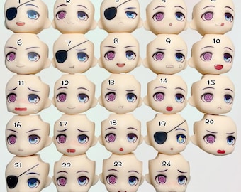 May include: A collection of twenty-four doll heads with various facial expressions. Each head is a pale skin tone with detailed eyes and different mouth shapes. Some heads have eye patches.