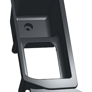 May include: A 3D-rendered, dark gray, rectangular component with a hollow interior and a circular hole. The component has a base with two holes and two supporting legs.