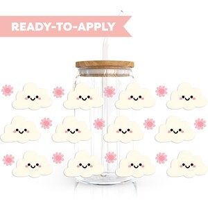 May include: A glass jar with a wooden lid and a straw. The jar is decorated with white cloud stickers with pink flowers. The text "READY-TO-APPLY" is on a pink banner.