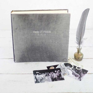 Luxurious, soft, velvet photo album. Shown in the 12x12 inch size, and silver velvet color. Options to personalize with one of our art emblems, or add your own text for additional cost. Two lines of custom personalization shown here in center