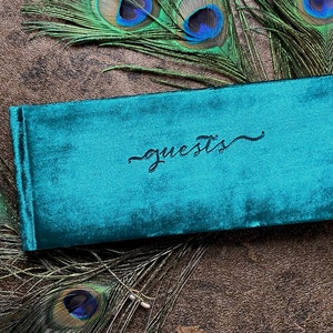 Small velvet guest book. 4x10 inches, landscape format. Soft velvet cover in a rich peacock green color. guests emblem stamped in center. Lined or blank page options available. Option to add name in corner for added cost. Intimate, small weddings