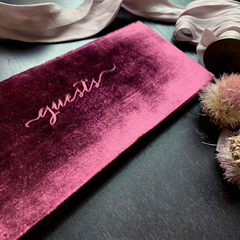 Small velvet guest book. 4x10 inches, landscape format. Soft velvet cover in a rich wine color. guests stamped in center. Lined or blank page options available. Option to add name in corner for added cost.