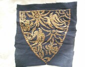 Metal embroidery applique on black crepe