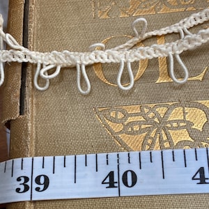 Button loop trim in two colors cream and red
