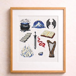 May include: Cross-stitch artwork in a wooden frame featuring fantasy-themed icons. Includes a cauldron, mountain, wings, stairs, sword, book, ribbon, fire, ring, and harp. The color palette is primarily blue, white, and brown.