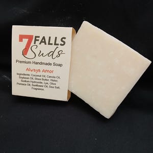 May include: A bar of white handmade soap with the label "7 FALLS Suds Premium Handmade Soap Always Amor" and a list of ingredients.