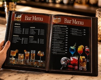 May include: An open bar menu featuring two pages with dark backgrounds, white text, and color photographs of various cocktails. The left page lists spirits, digestifs, and bitters, while the right page displays signature cocktails with prices.