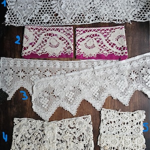 May include: Assortment of white lace trims in various patterns. Includes floral, geometric, and scalloped edges. Some pieces are wide, while others are narrow. The lace is displayed on a dark wood surface.