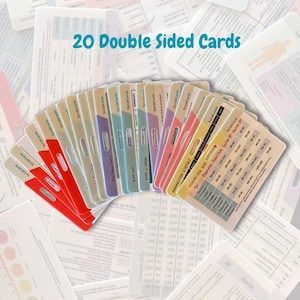 May include: A set of 20 double-sided reference cards for medical professionals, featuring various color-coded tabs and printed clinical data including pediatric vital signs, blood glucose levels, and immunization schedules on a white background.
