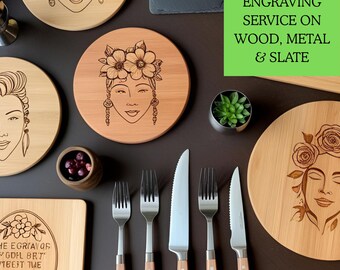 May include: A collection of wooden and slate coasters with laser engraved designs. The coasters feature various images, including a woman's face, flowers, and a floral design. The text "Greeting Deavi with Your Aesem" is engraved on a black slate coaster. The text "LASER ENGRAVING SERVICE ON WOOD, METAL & SLATE" is displayed on a green background.