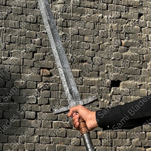 Close up of Damascus steel Knight Templar Sword blade showing layered pattern and double edged design on a medieval inspired decorative sword