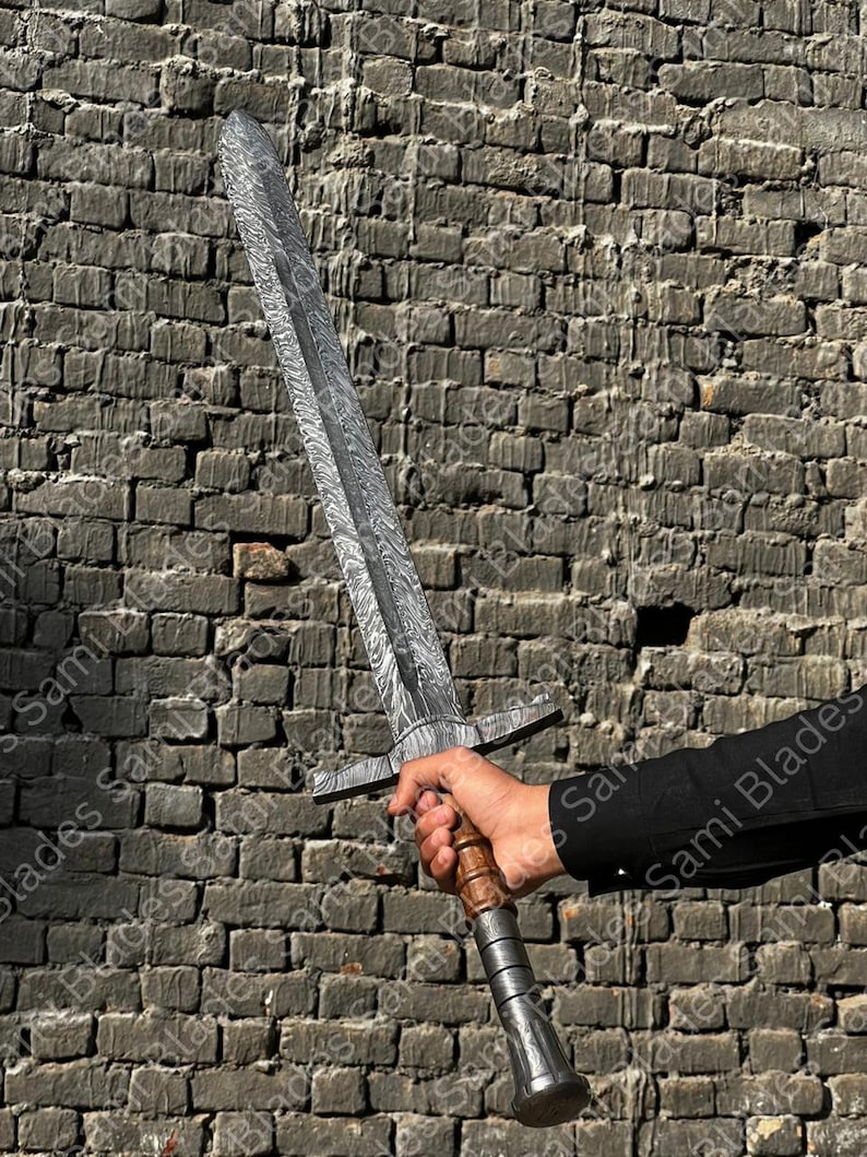 Close up of Damascus steel Knight Templar Sword blade showing layered pattern and double edged design on a medieval inspired decorative sword