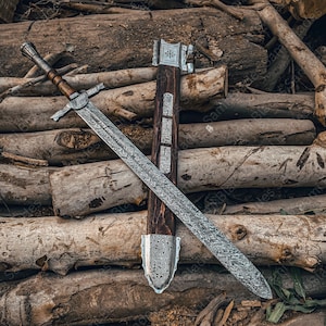 Hand forged Damascus steel Knight Templar Sword with double edged blade and hardwood handle, displayed with matching scabbard on a neutral background
