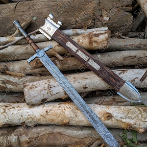 Angled view of a handcrafted Damascus steel Knight Templar Sword with scabbard highlighting detailed craftsmanship