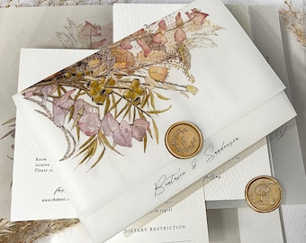 May include: Wedding invitation suite featuring a floral design with dried flowers in shades of pink, yellow, and brown. The invitation includes a wax seal and the names "Beatrice & Sanderson".