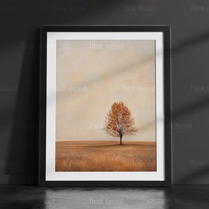 May include: Framed art print featuring a solitary tree with orange leaves in a field of brown grass. The artwork is set against a soft, neutral background, framed in black. The words "Think decent" are printed on the frame.