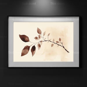 May include: A framed watercolour print depicting a branch with brown leaves on a beige backdrop. The artwork has a minimalist style, with soft brushstrokes and a neutral colour palette. The frame is silver.