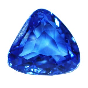 May include: A deep blue gemstone with a triangular shape and a faceted cut.