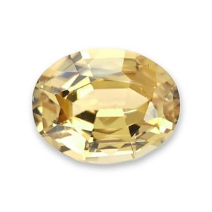 May include: A loose oval-cut gemstone with a pale yellow hue and a faceted surface. The stone displays a high level of clarity and brilliance, with multiple geometric facets reflecting light across its polished, transparent, and light golden surface.