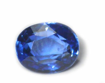 May include: A deep blue oval-shaped sapphire gemstone with a faceted cut.