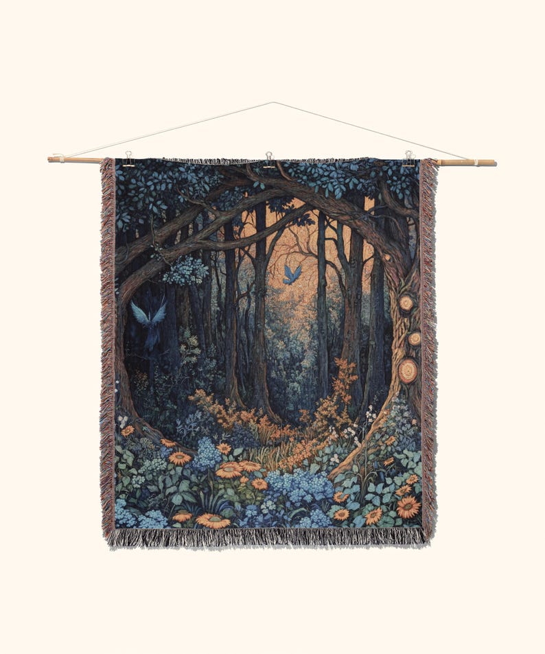 May include: A rectangular woven tapestry featuring a dark forest scene with tall trees, blue birds, and orange and blue flowers. The tapestry has a fringed edge and is suspended from a wooden rod with a string for hanging, displaying a detailed landscape.