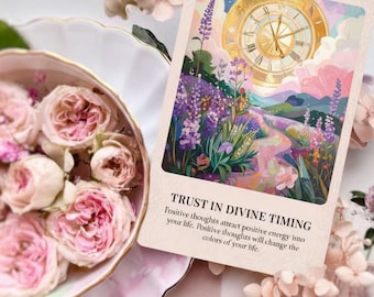May include: An oracle card with the text "TRUST IN DIVINE TIMING" and a colourful illustration of a clock, flowers, and a path. Pink roses in a decorative dish and delicate flowers surround the card, creating a soft, feminine aesthetic.