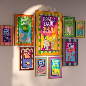 May include: A selection of framed Roald Dahl book covers, such as "The BFG" and "Charlie and the Chocolate Factory." The frames are different sizes and colours, forming a colourful wall arrangement. The book covers display bright illustrations.