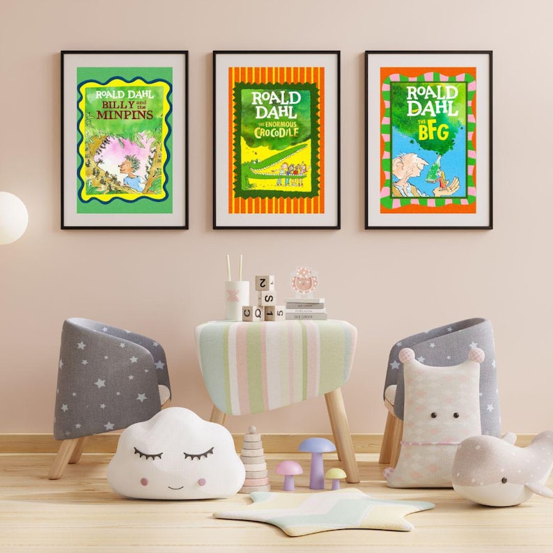 May include: Three framed book covers by Roald Dahl: "Billy and the Minpins", "The Enormous Crocodile", and "The BFG". Each features colourful illustrations and text on a black frame. The room includes children's furniture and decorative items.