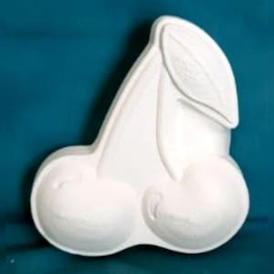May include: White ceramic cherry mold with a single leaf on top. The mold is designed to create two cherries.