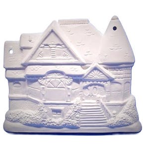 May include: A white, unpainted ceramic house ornament featuring a detailed Victorian-style facade with a pointed turret, gabled roof, front porch steps, and textured shrubbery at the base. The piece includes two small holes for hanging purposes.